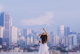 girl facing cityscape