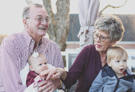 grandparents with tots on their laps