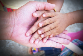 three generations' hands together