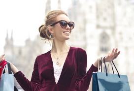 a happy young woman with shopping gift bags