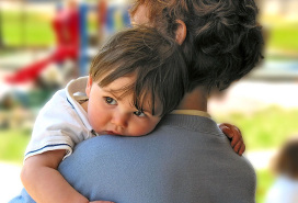 tot laying head on grandma's shoulder