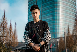 worried young man in front of an office tower